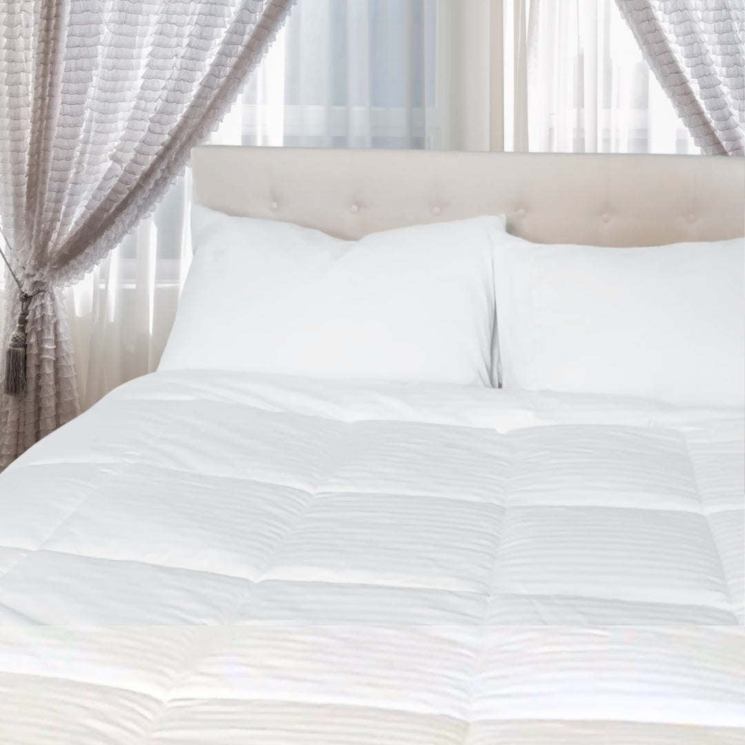 A stylish bedroom with a tufted headboard and a cozy white duvet. The text highlights the "Affinity Collection" from Continental Bedding.