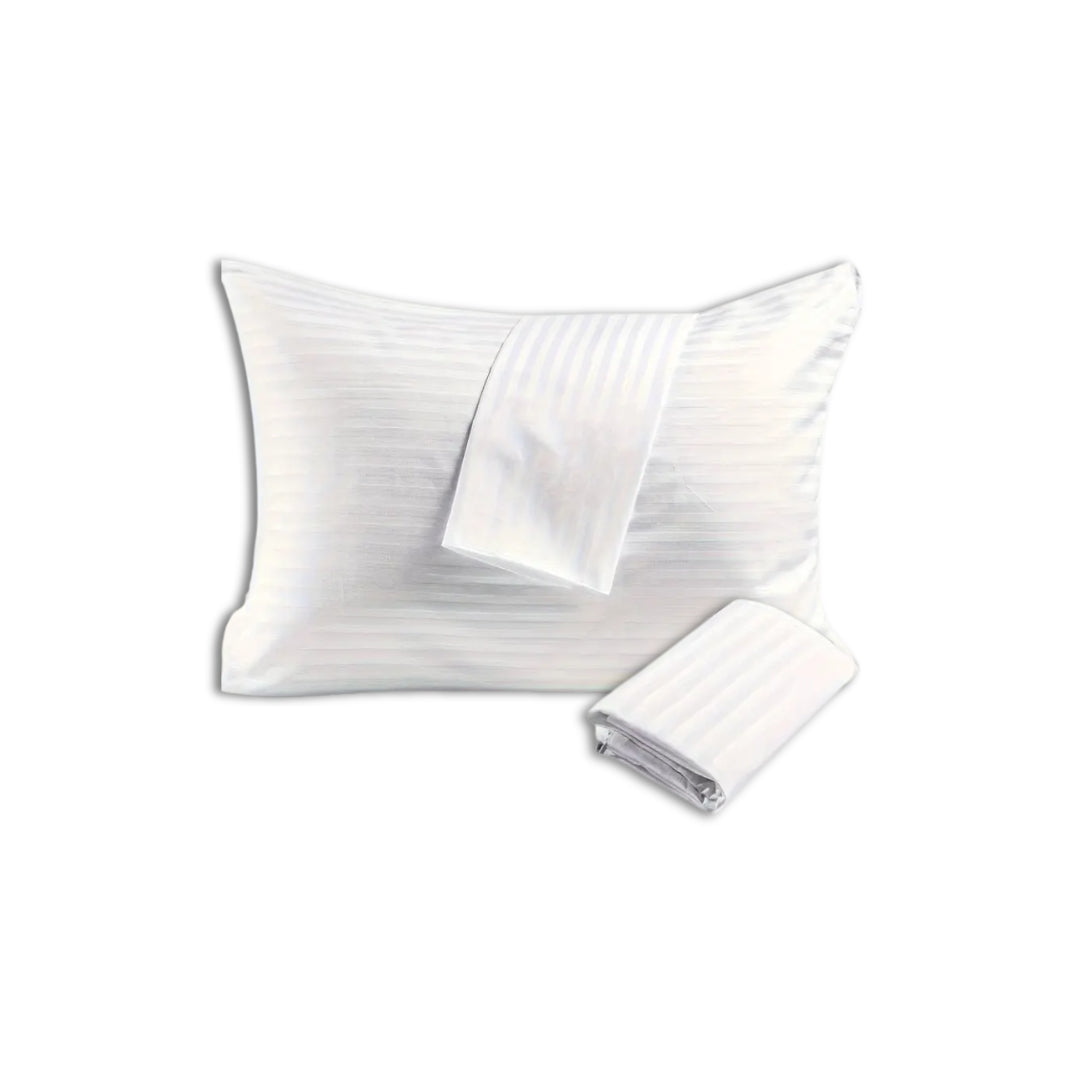 White pillow with matching striped cotton pillowcases, one folded and one draped, showcasing elegant hotel-style bedding.