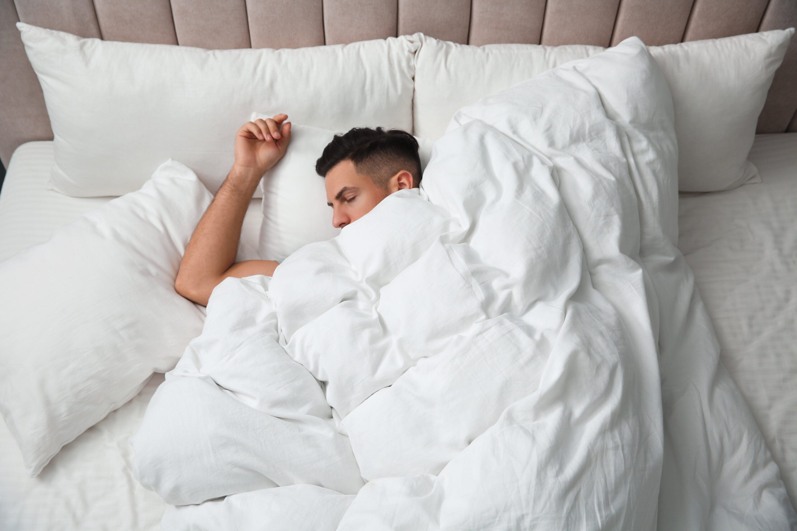 Handsome,Man,Sleeping,Under,Soft,Blanket,In,Bed,At,Home,