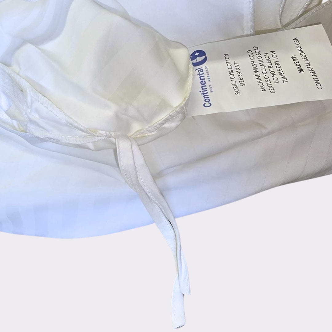 Inside view of toddler duvet protector showing corner tie and product tag from Continental Bedding
