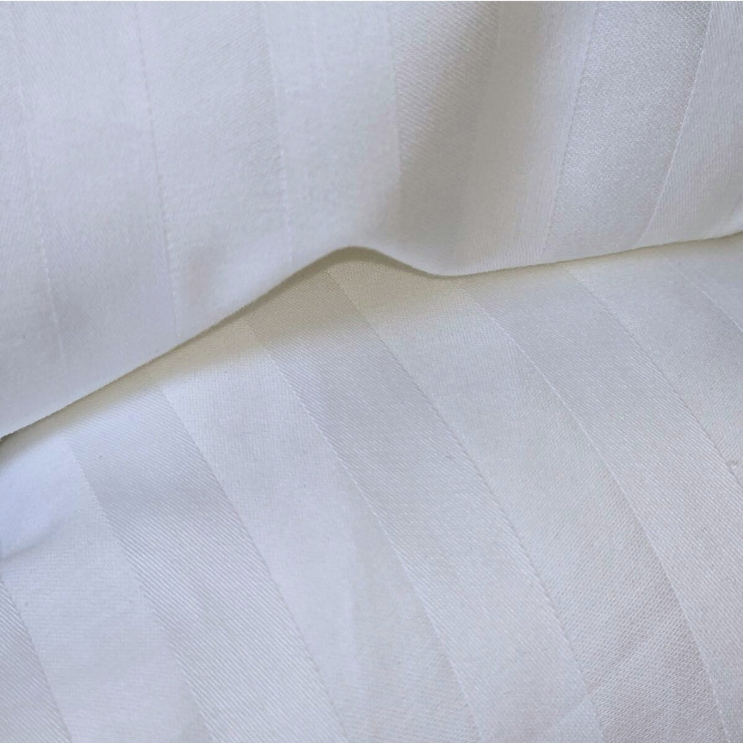 Detailed view of soft damask stripe fabric texture on duvet protector
