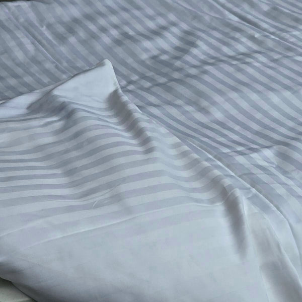 Close-up of white damask stripe cotton fabric used in toddler duvet protector