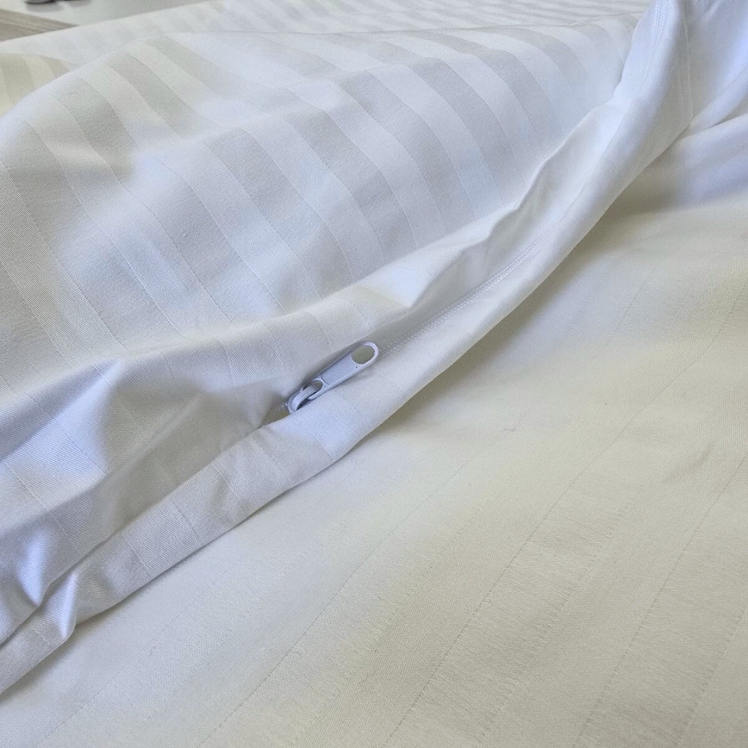 Zipper closure detail on toddler duvet protector lying flat on bed

