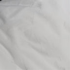 White fleece zippered pillow protector displayed on a plush pillow, showcasing its soft texture and protective cover